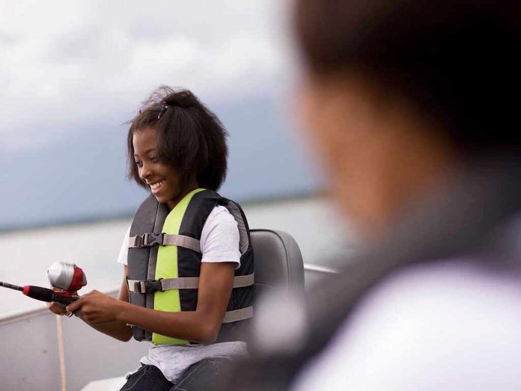 Child wearing life jacket on a boat