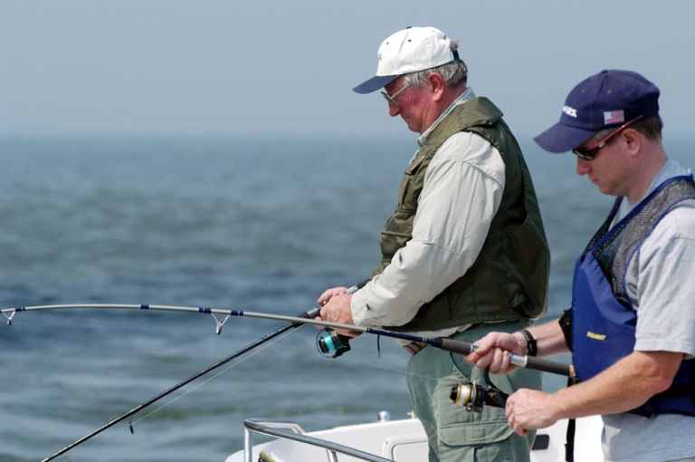 Anglers fishing on a boat.