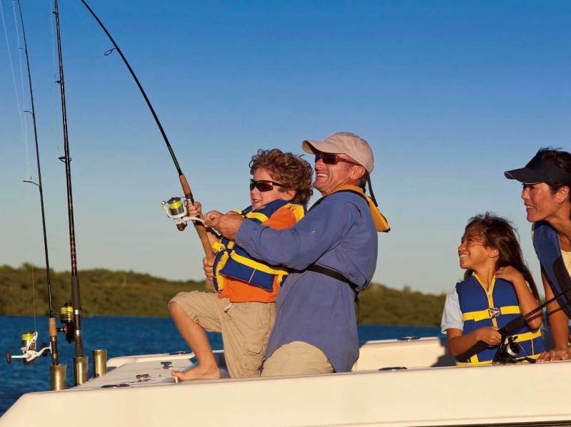 Family wearing life jackets while fishing